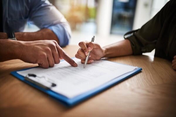 lawyer, broker or hr manager signing a contract agreement with client or employee. financial advisor asking for womans signature for insurance, legal paperwork or claim document
